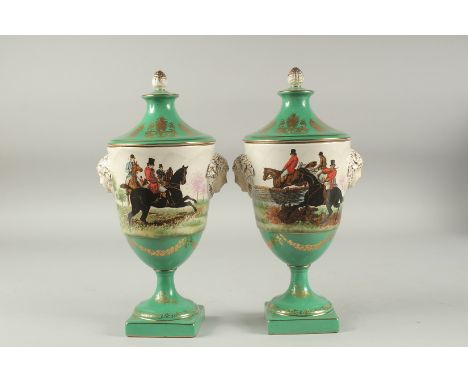 A PAIR OF SEVRES DESIGN PORCELAIN URN SHAPED VASES AND COVERS decorated with hunting scenes. 12ins high.