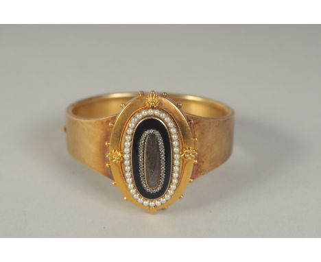 A GOOD 15CT GOLD VICTORIAN MOURNING BANGLE with black enamel and seed pearls