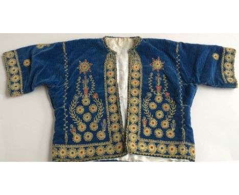 An early 20th century Palestinian wedding jacket of blue corduroy with gold and red floral embroidery (small).