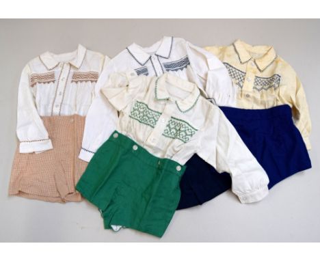 Four 1960s oufits for a small child, the blouses of cream viyella, two smocked in blue to button to blue shorts, one green wi