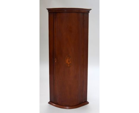 A 19th century mahogany corner cupboard, inlaid with a hardwood and boxwood floral reserve, on a later bracket
