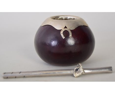 A lacquered gourd and white metal ash tray with horse shoe detail, and white metal straw decorated with horses head and a pew