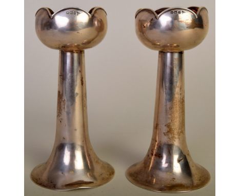 A pair of sterling silver Art Deco candlesticks with stylised leaf pattern to top, hallmarked Sheffield 1913, 212g