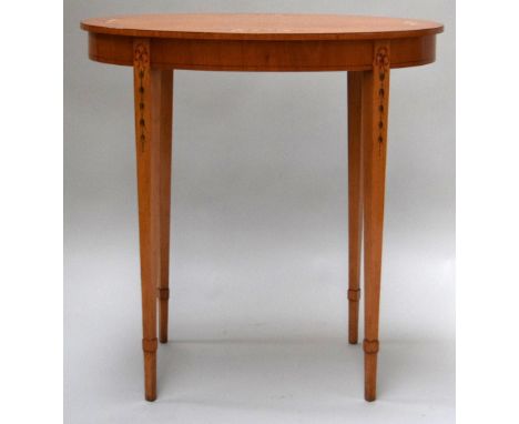 An oval rosewood side table with inlay in the George III taste on square tapered legs with panel capitals retailed by Brights