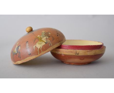 A 19th century wooden circular trinket box decorated with figures playing polo and arabic script, 10cmD 7cmH