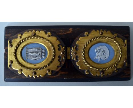A set of wooden adjustable bookends with jasperware ceramic cameos to the ends retailed by T. Russell of Brighton, 33cmL