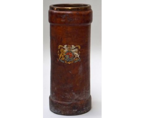 A leather and gilt metal stick stand in the form of a late 19th century shell case bearing royal arms