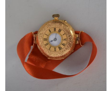 A ladies 18ct gold cocktail watch with filigree design and Roman numerals, 28g