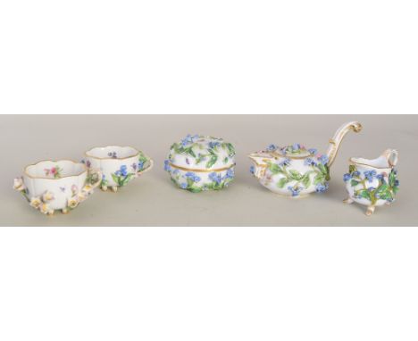 A matching Meissen tea service, comprising a teapot, two teacups, a cream jug and a lidded sugar bowl, all painted with flora