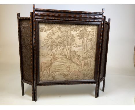 A vintage folding fire screen with fabric scene of woodland glen with deer. W:86cm x H:77cm