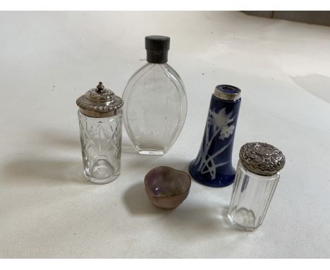 a collection of silver topped and white metal glass and ceramic items also with an engraved glass bottle 