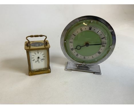 A brass carriage clock with key also with a chrome Art Deco style clock 