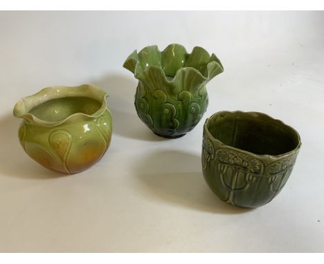 Three Art Nouveau style green planters. Bretby planter with flared wavy edge. Marked Bretby 825. H: 23cm. Portland and one ot
