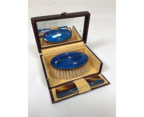 Early 20th century travel brush and comb set. Blue guilloche enamel with painted rose motif. Horse hair bristles with tortois