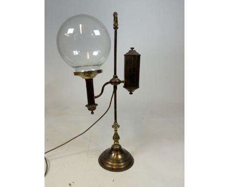 An early 20th century adjustable stundents lamp with glass shade, later wired for electric. Untested. Approx H:60cm