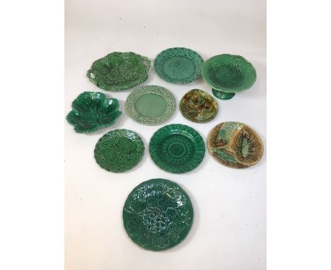9 assorted ceramic plates and a cake stand. Various leaf patterns in green hues. A/F&nbsp;