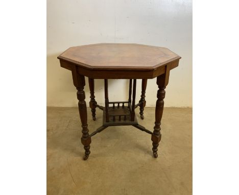 A 20th century octagonal inlaid table on.castors with galleried under shelf. W:75cm x D:75cm x H:72cm