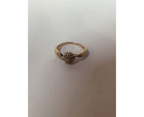 A nine carat gold diamond cluster ring. Size 9.5