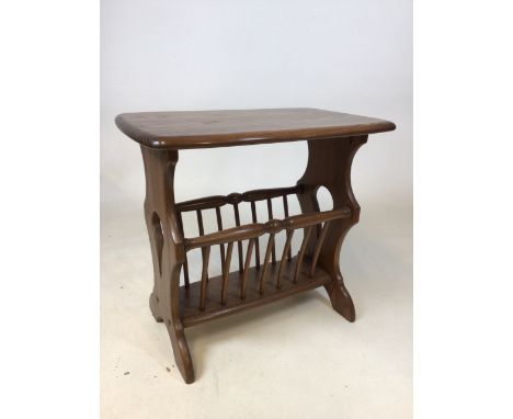 An Ercol coffee table with built in magazine rack. Ercol badge to side W:54cm x D:36cm x H:51cm