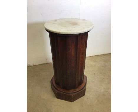 Early 20th century. Unusual fluted column style planter stand with marble plinth top over a cabinet door with a pair of shelv