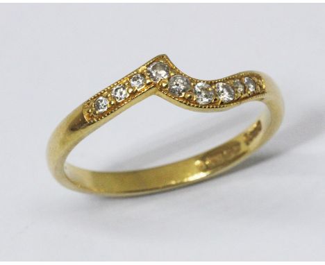 A diamond wishbone ring, nine millegrain set diamonds, hallmarked 18ct yellow gold, gross wt. 2g, size L/M.  Condition - good