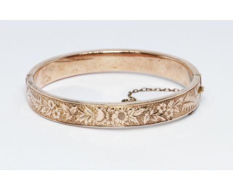 A hallmarked 9ct rose gold bangle, wt. 10.7g, diam. 5.5cm.  Condition - general wear including light dings to exterior, clasp