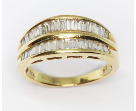 An 18ct gold diamond ring, two rows of channel set baguette cut diamonds weighing approx. 0.92cts in total, 18ct gold interna