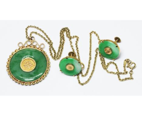 A Chinese green jadeite jade pendant, mounted in yellow metal unmarked, 44cm chain marked '18ct', chain wt. 5g, pendant wt. 8