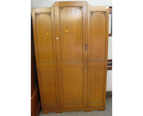 Oak Art Deco beaded wardrobe with carved fan decoration.