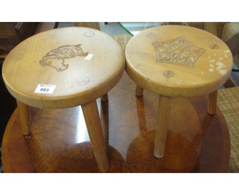Two similar small beech tripod stools carved with horse head and Tudor rose. (2)