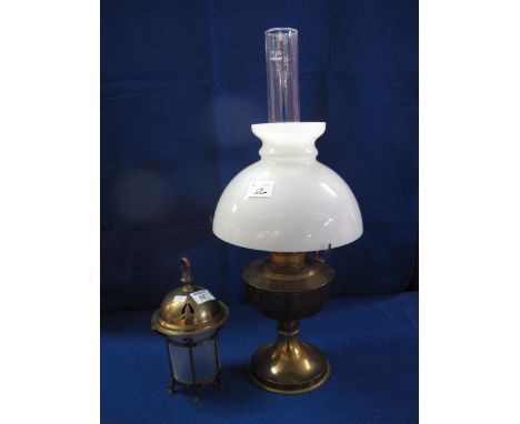 Brass single burner oil lamp with cream shade and glass funnel, together with small brass electric lantern. (2)