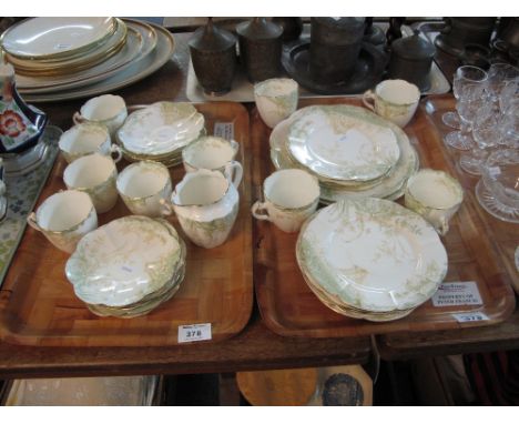 Two trays of Staffordshire tea ware items on a white ground with gilt and foliate decoration comprising tea cups and saucers,