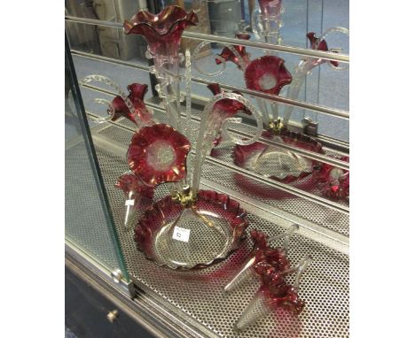 Victorian cranberry four stemmed epergne with three hanging baskets.