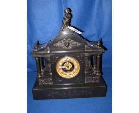 Late 19th/early 20th Century heavy slate, architectural style mantel clock with cherub decoration and finial, gilt metal face