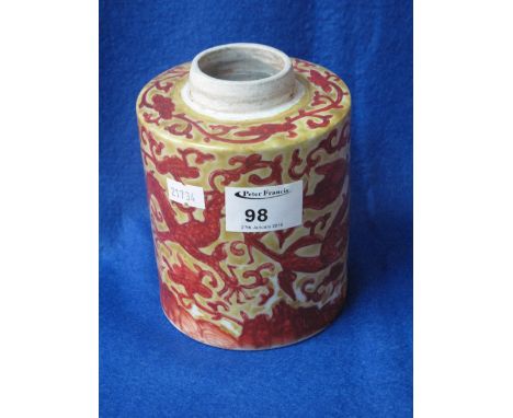 Chinese porcelain cylinder tea caddy missing lid, decorated with iron red dragons and stylized waves on a yellow ground. COND