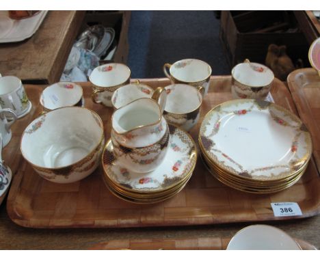 Tray of Wedgewood bone china tea set on a white ground with gilt branding and floral decoration, comprising tea cups and sauc