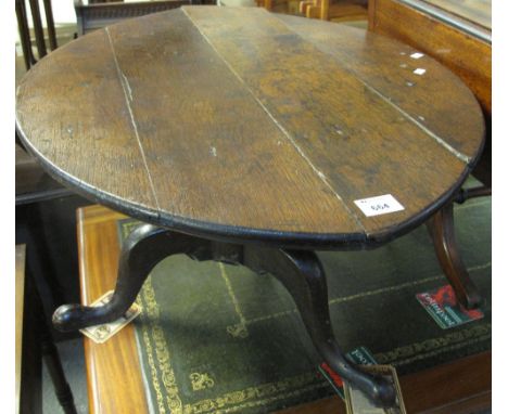 Oak tripod table on pad feet.