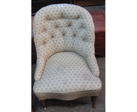Late Victorian button back upholstered bedroom chair on casters.