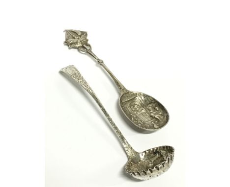 A Victorian silver sifting spoon with repousse grape and fruit decoration to bowl: Glasgow 1891 together with a Continental s