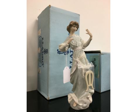 A Lladro china figure modelled as a young woman in long dress playing a harp (harp detached).