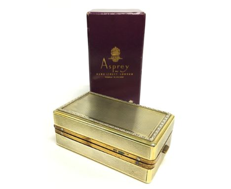 A gilded engine turned Asprey style travelling burner in later Asprey box.