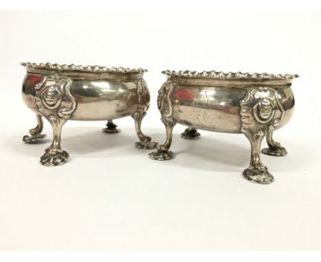 A pair of 18th century heavy silver salts resting on four pad feet by D. & R. Hennell: London (marks rubbed but Circa 1766), 