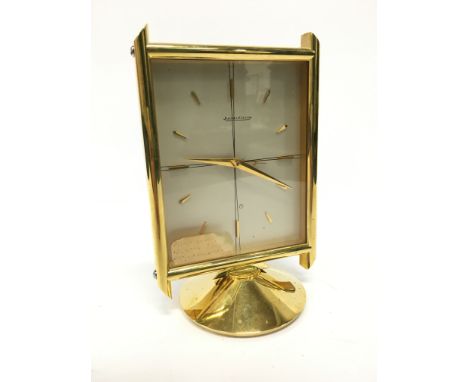 A mid 20th century mantle clock by Jaeger-Le-Coultre, brass and glass cased in the modernist style.