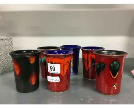 A set of six Living Glaze Poole Pottery miniature vases decorated in various patterns.
