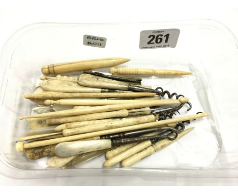 A carton containing various early 20th century ivory button hooks and similar items.