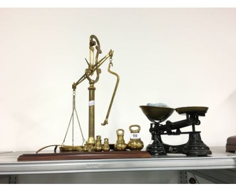A pair of brass balance scales and bell weights together with another pair of scales.