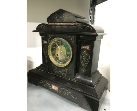 A late 19th century black slate mantle clock.