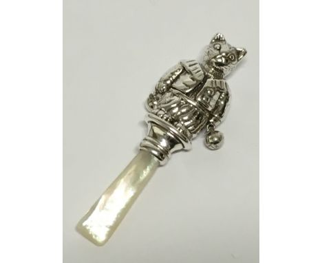 A babies' silver mother of pearl teether with cat finial.