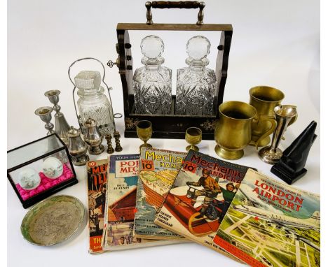 A tantalus, metalware, books, and ceramic eggs in a case