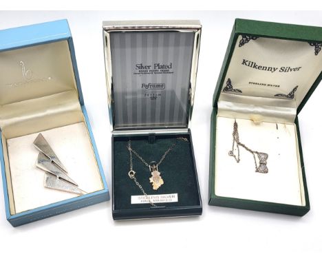 Three boxed silver pendants including a silver bow with a single rub over set stone set with cubic zirconia on a trace link c